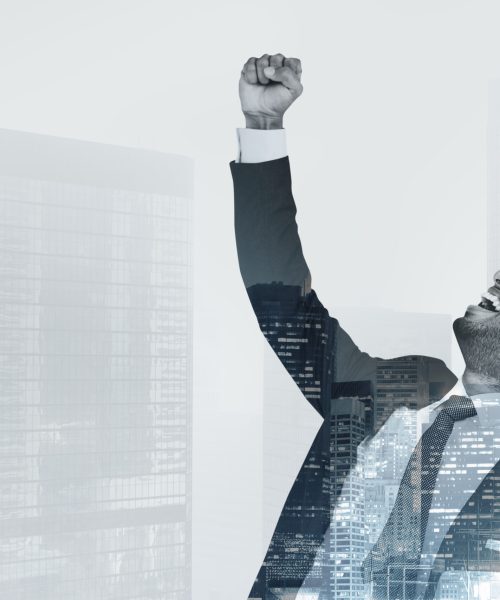 Successful businessman raising his hand in the air Successful businessman raising his hand in the air